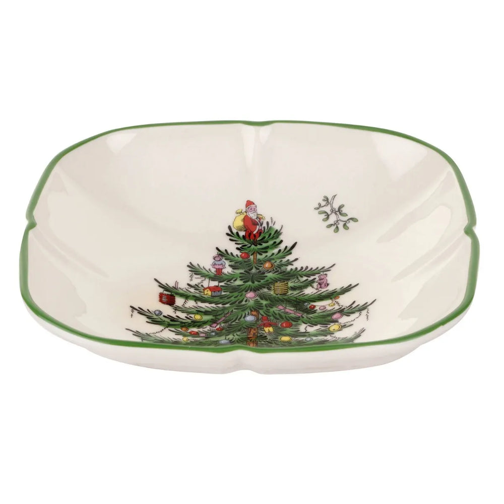A white ceramic Christmas bowl with a green rim, featuring a printed Christmas tree with Santa Claus and a small snowflake on a white background.