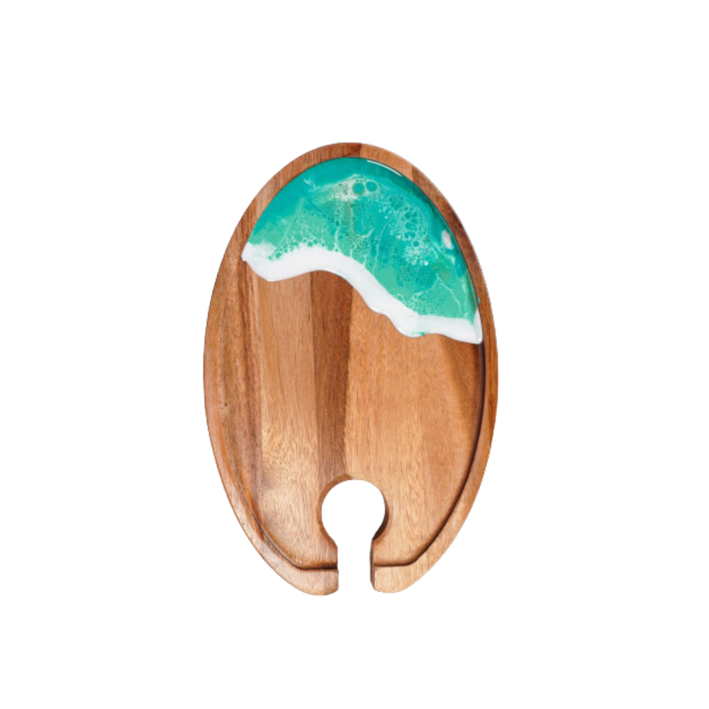 Wooden coaster with a green and white wave design on a white background