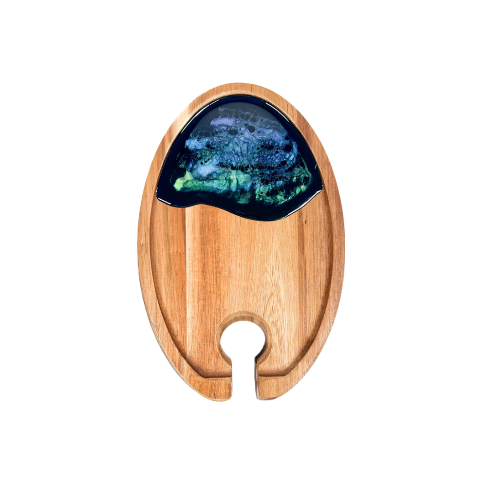 Wooden cutting board with a decorative blue and green stone inlay on a white background