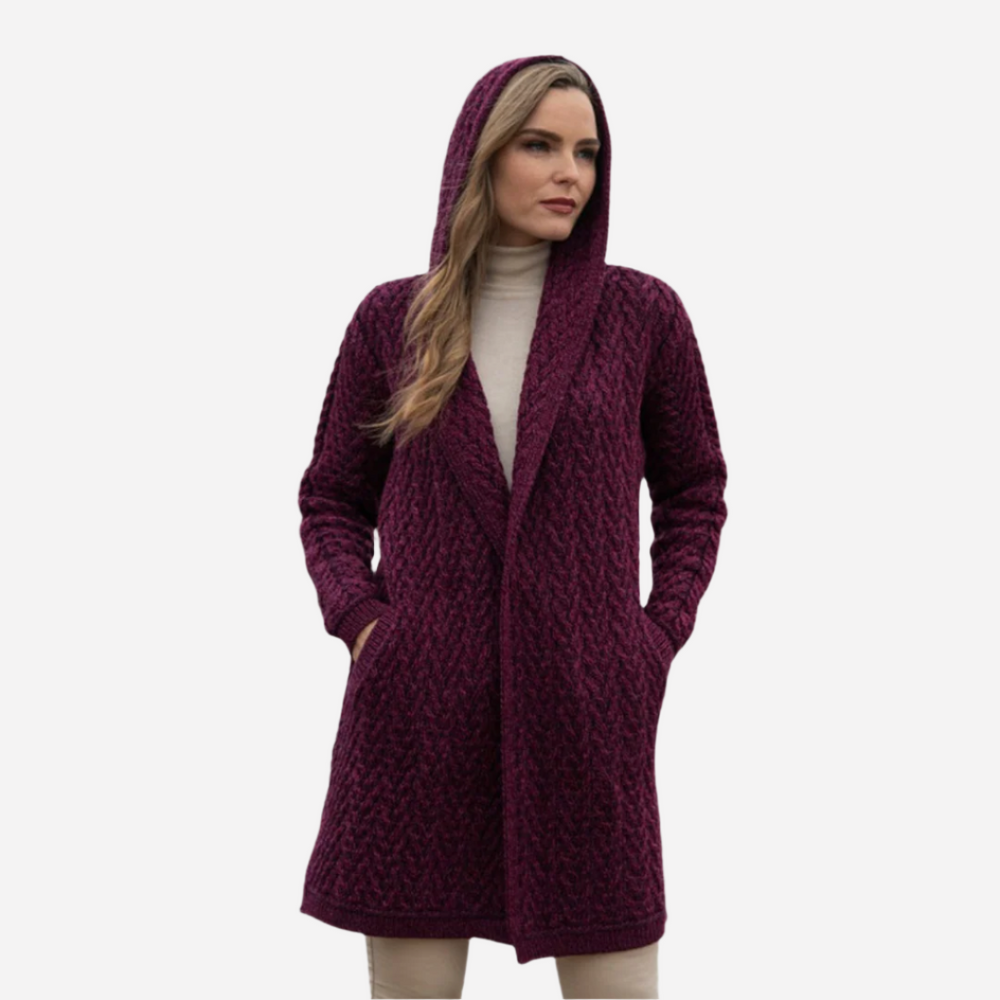 Woman wearing a purple hooded coat on a gray background