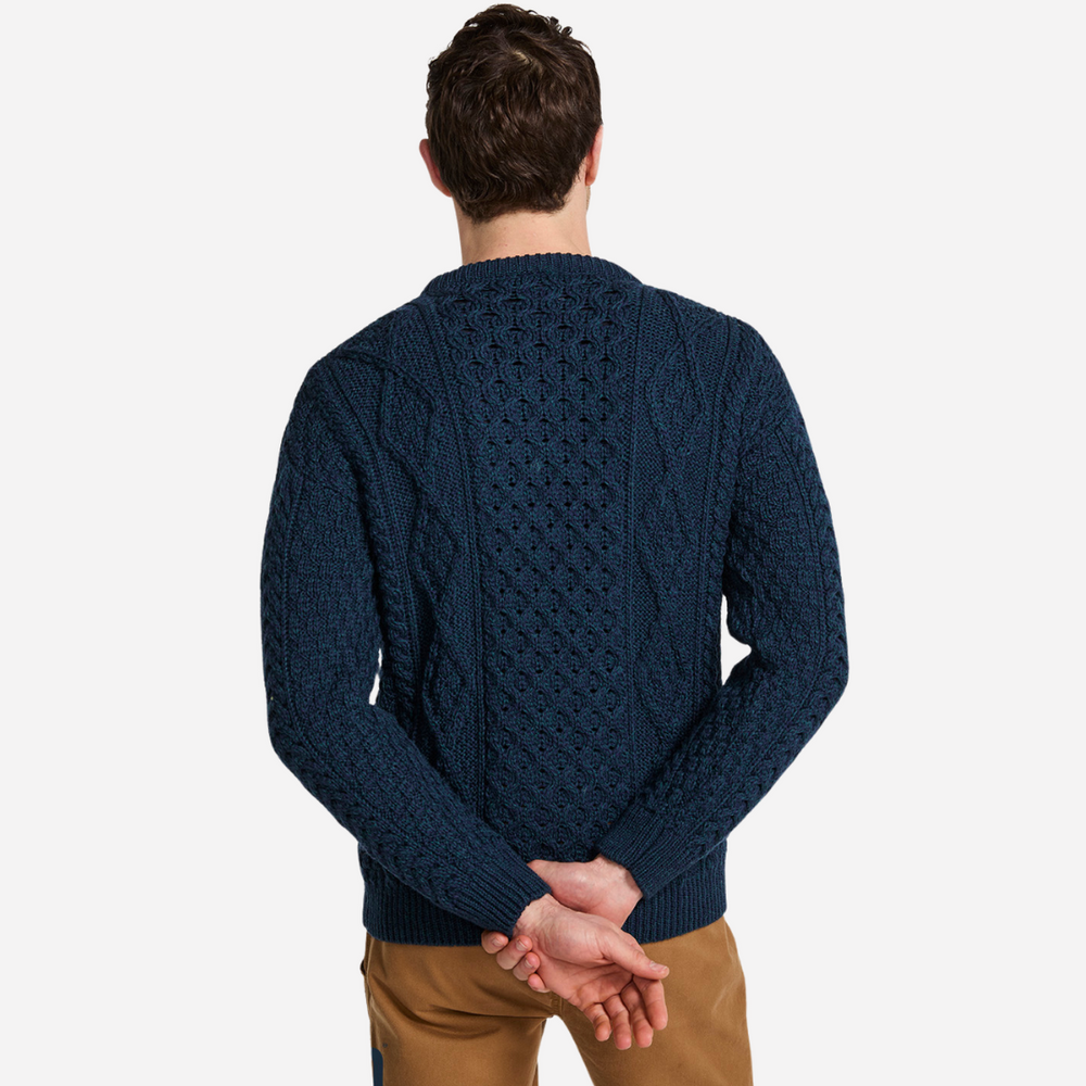 Man wearing a blue knitted sweater on a white background