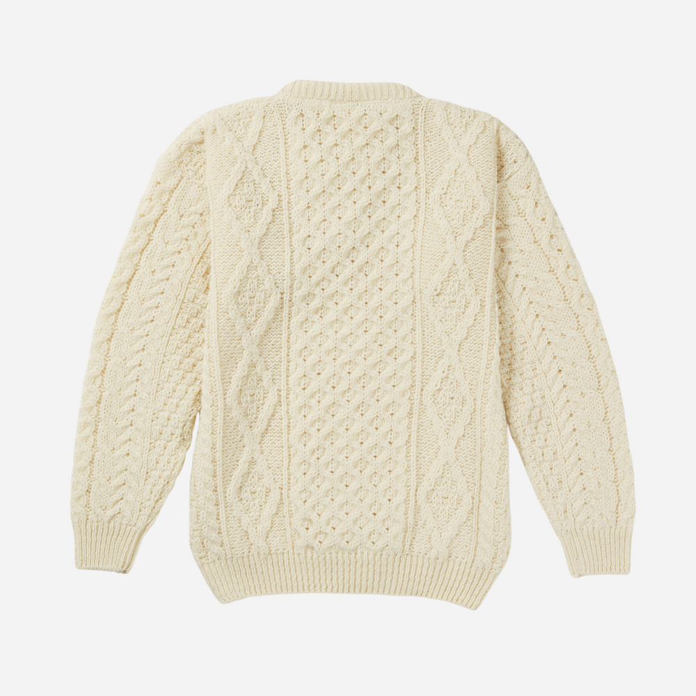 Cream-colored cable knit sweater on a white background