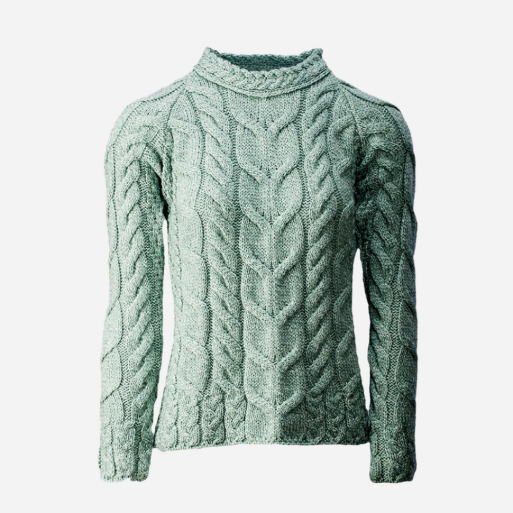 Green cable knit sweater on a white background