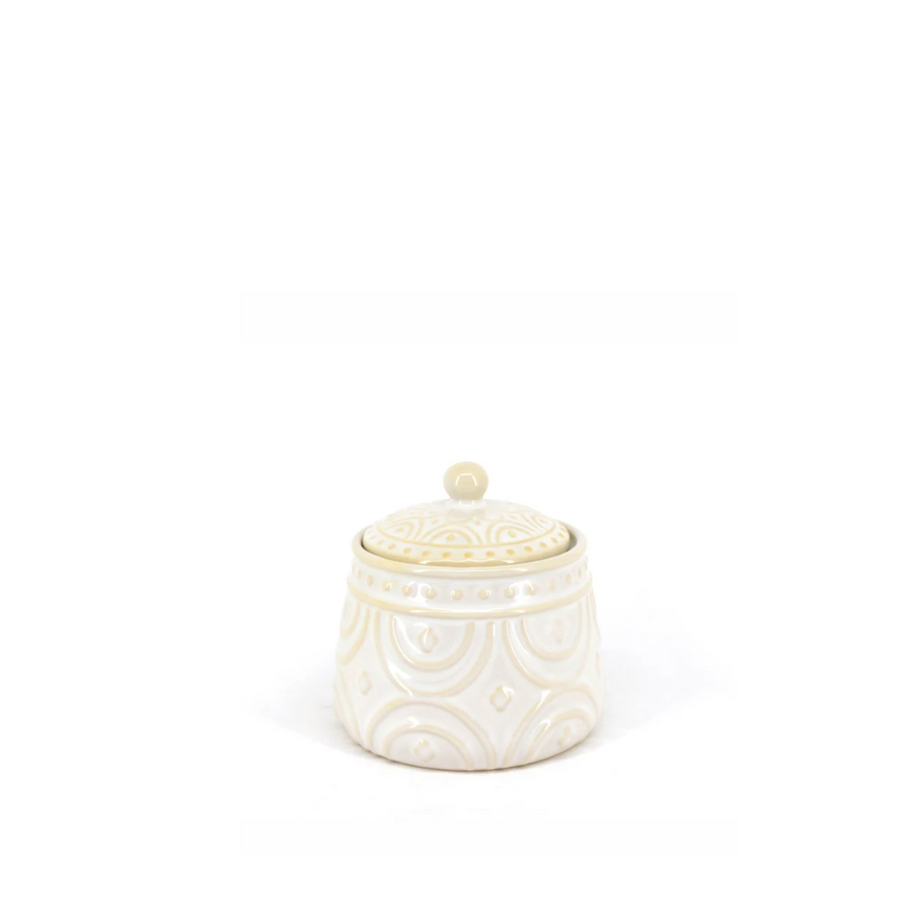 A beige textured sugar bowl with a lid, possibly ceramic or porcelain, with a classic farmhouse design.