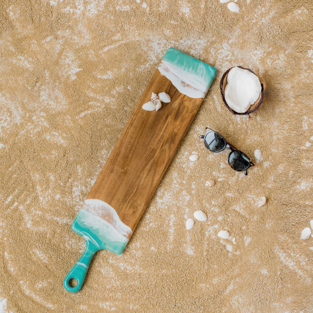 This baguette board made of Acacia wood and crafted with natural eco-friendly turquoise/white epoxy