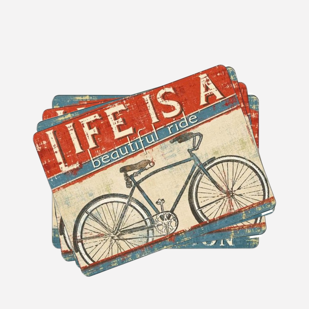 A set of four rectangular cork-backed placemats with a vintage bicycle design and the text 'LIFE IS A beautiful ride'.