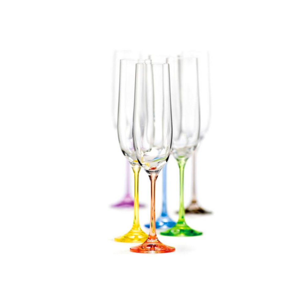 A set of six Bohemia Rainbow Flute Glasses with colored bases, standing upright. The glasses have a sleek design with a gradient of color at the base transitioning into a clear glass.