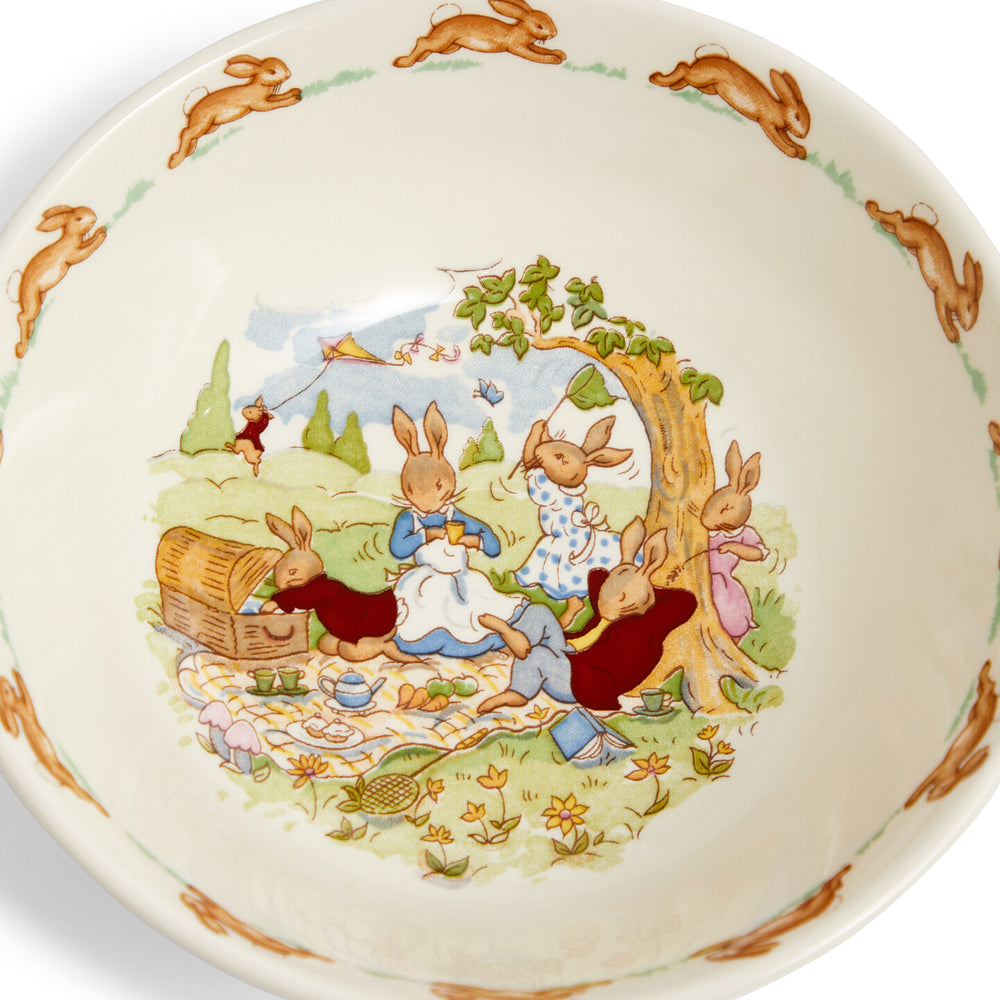 Ceramic bowl with a decorative design of rabbits at a picnic 