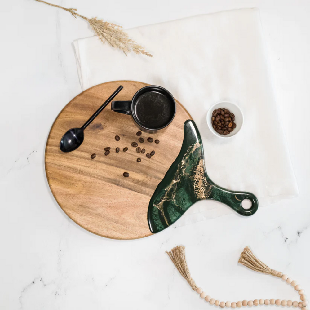 A 12" diameter cheese paddle by Lynn & Liana combines Acacia hardwood and an eco-friendly Jade epoxy.