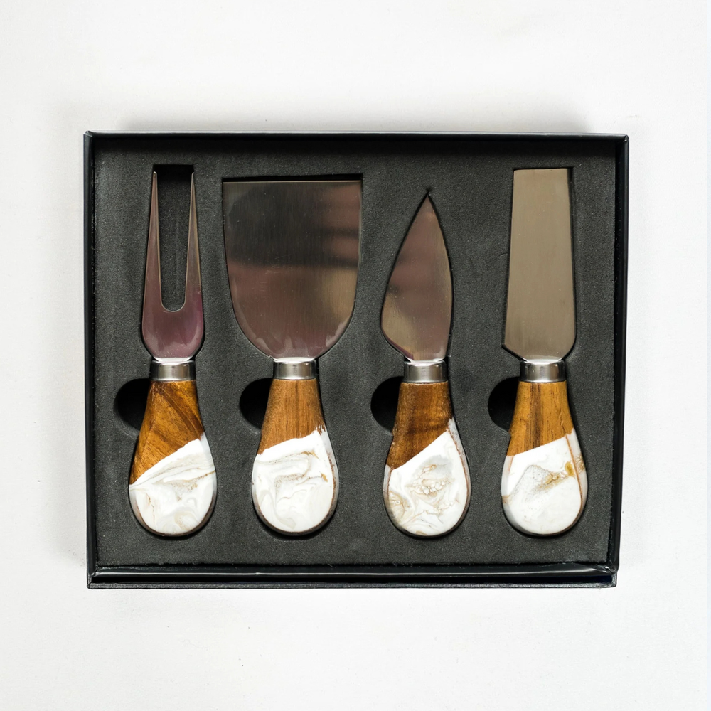 A set of four cheese knives with wooden gold quartz motif epoxy handles and stainless steel blades, displayed in a black box.