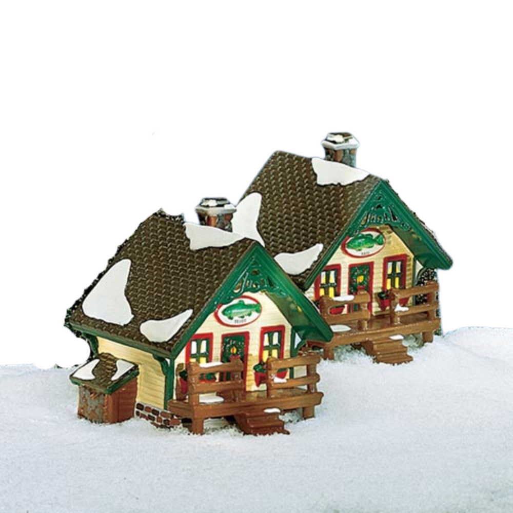 Two model houses with snow on the roofs on a white background
