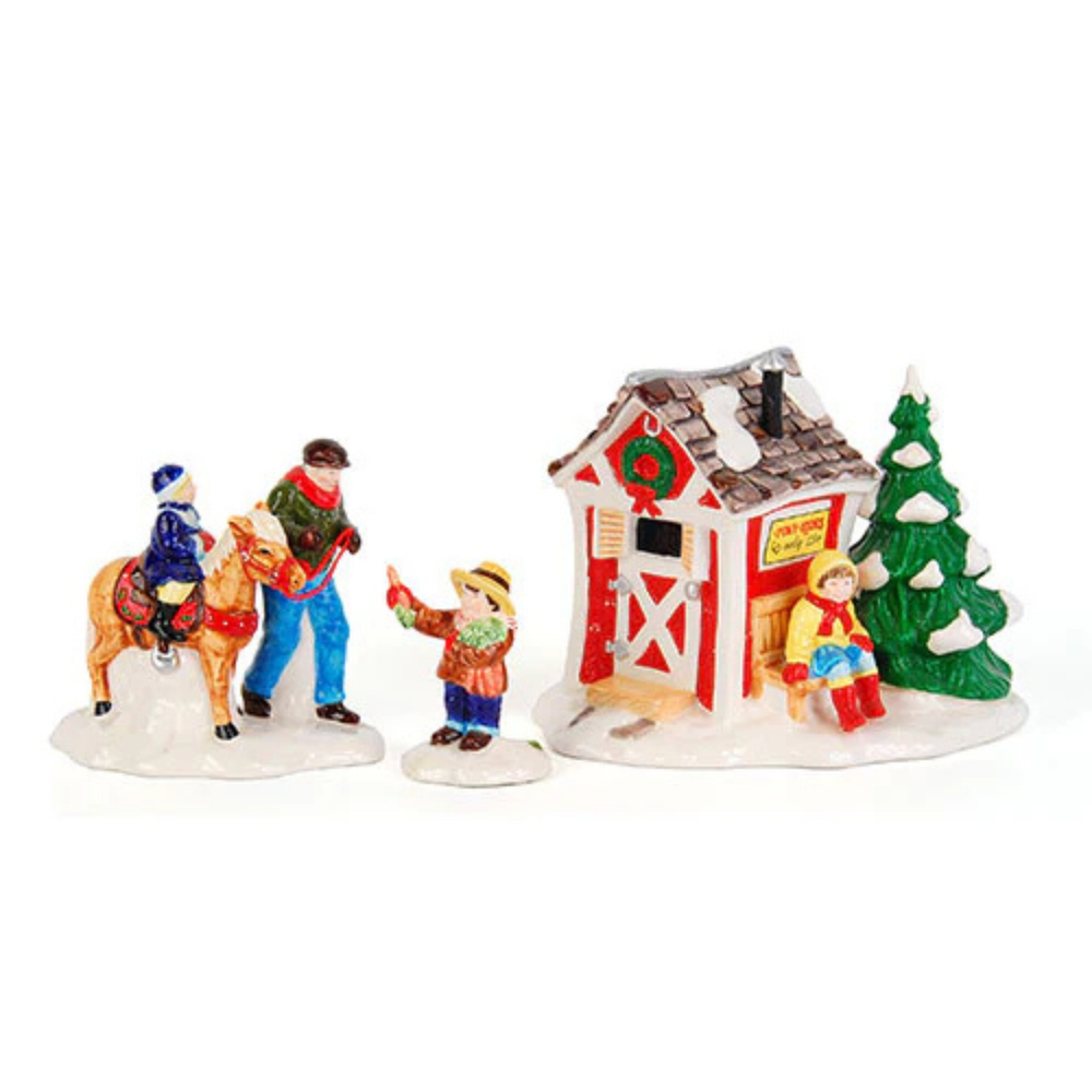 A figurine on a horse with another 3 figurines in front of a small stable. Against a white background.