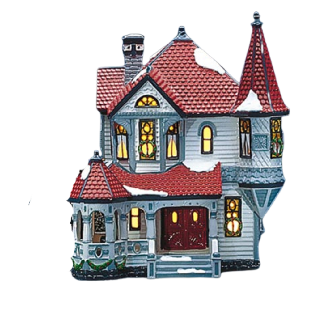 Decorative model of a Victorian-style house with a red roof on a white background