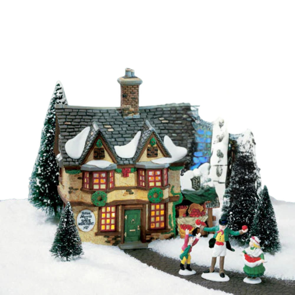 Christmas-themed village scene with a house, trees, and animated figures on a snowy background.