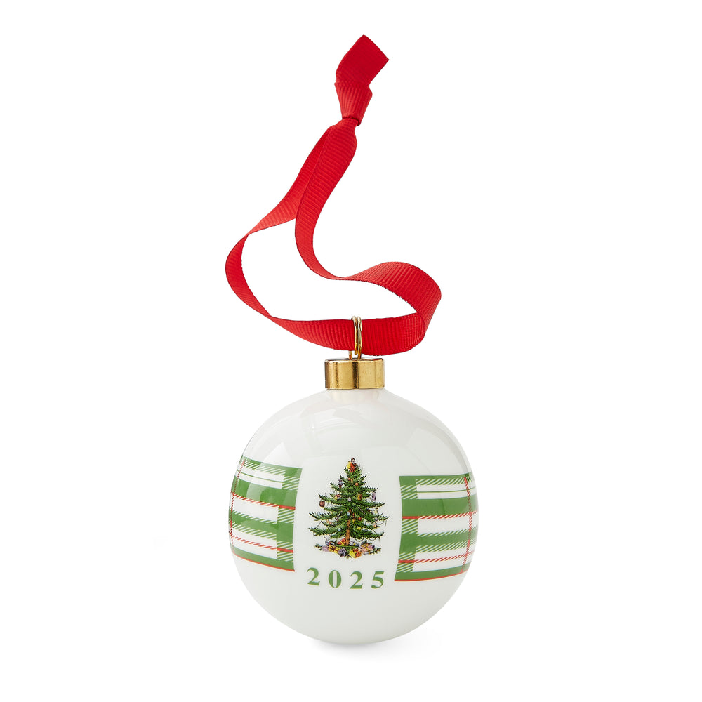 White Christmas ornament with a decorated tree and "2025" in green. It has a red ribbon and gold top, conveying a festive and joyful tone.