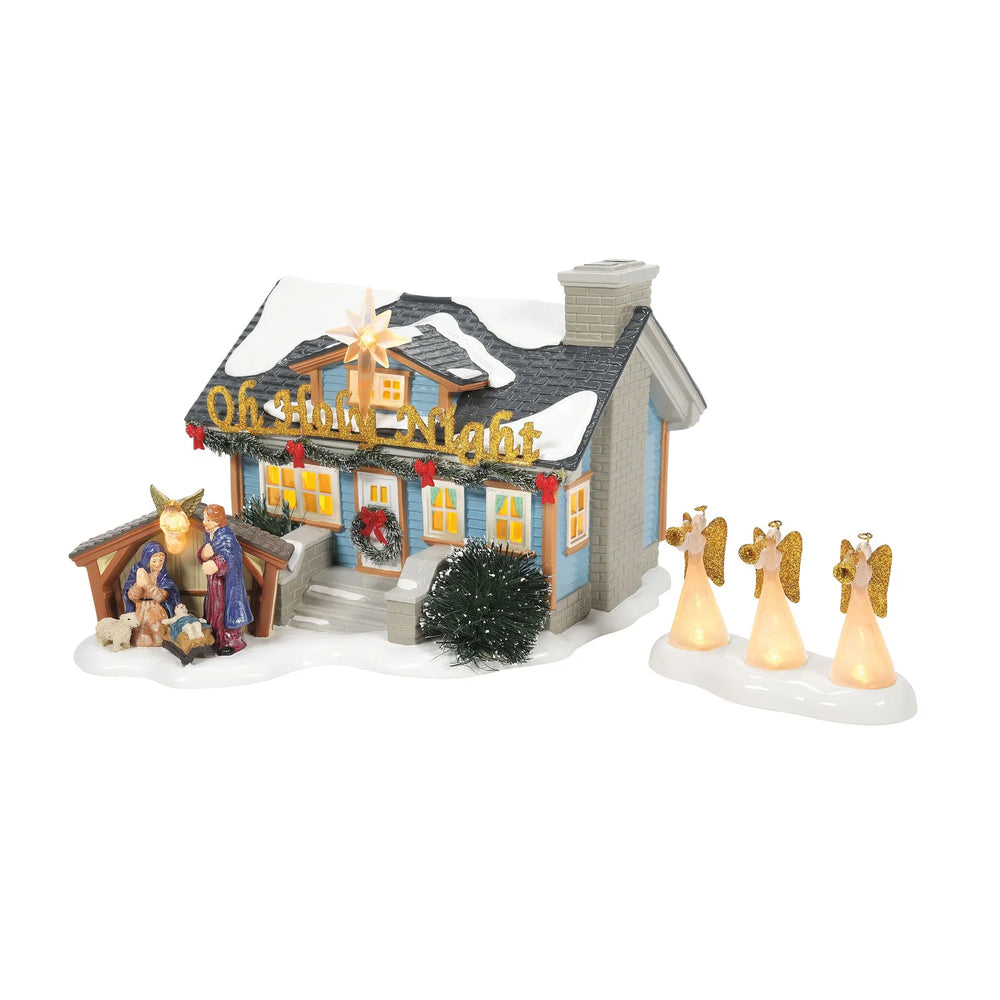 Christmas-themed miniature house with nativity scene and angels on a white background