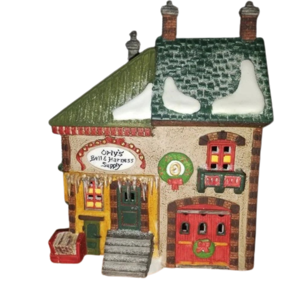 Decorative model of a quaint house with a green roof and colorful facade on a white background
