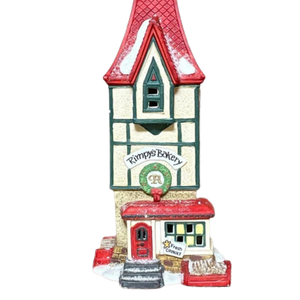 Decorative miniature building with a red roof and 'Pumpkin's Bakery' sign on a white background