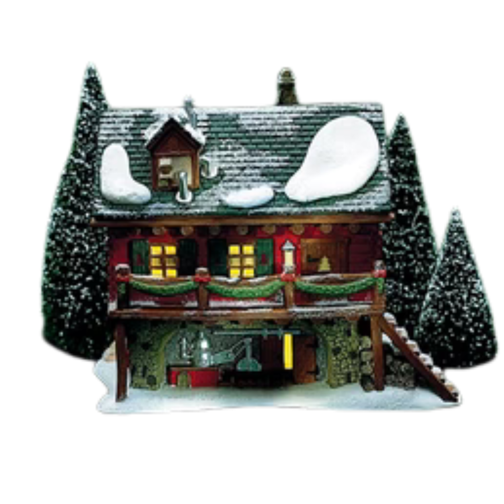 Decorative model of a snow-covered cabin with lights on a white background
