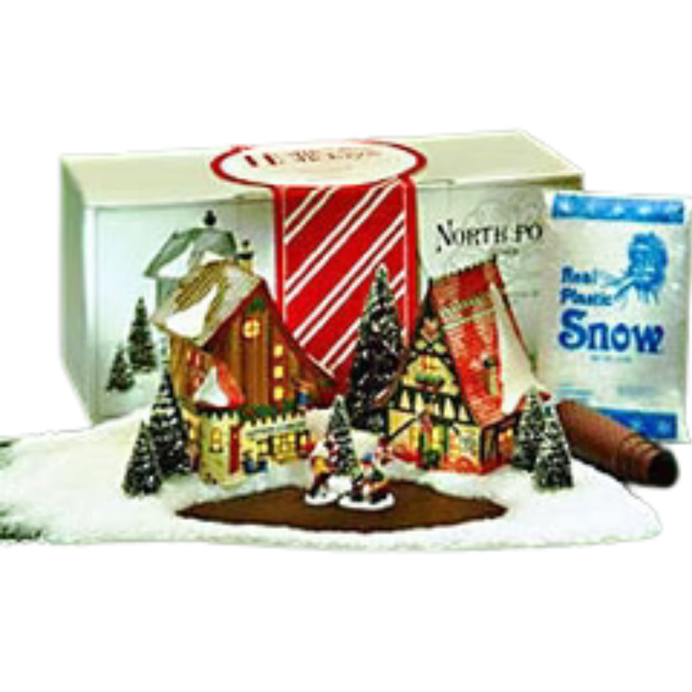 Christmas village scene with houses, trees, and a bag of 'Realistic Snow' on a white background.