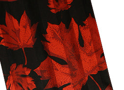 Close-up of red maple leaves on a black background