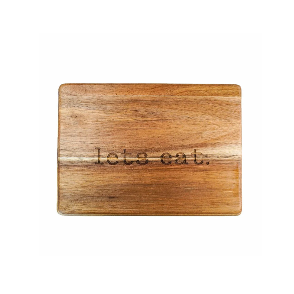 Engraved "let's eat" in typewritter font on a hardwood cheese board