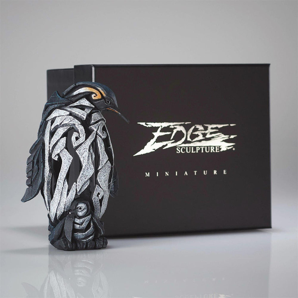 Decorative  penguin sculpture in front of a black box with 'Edge Sculpture' branding.