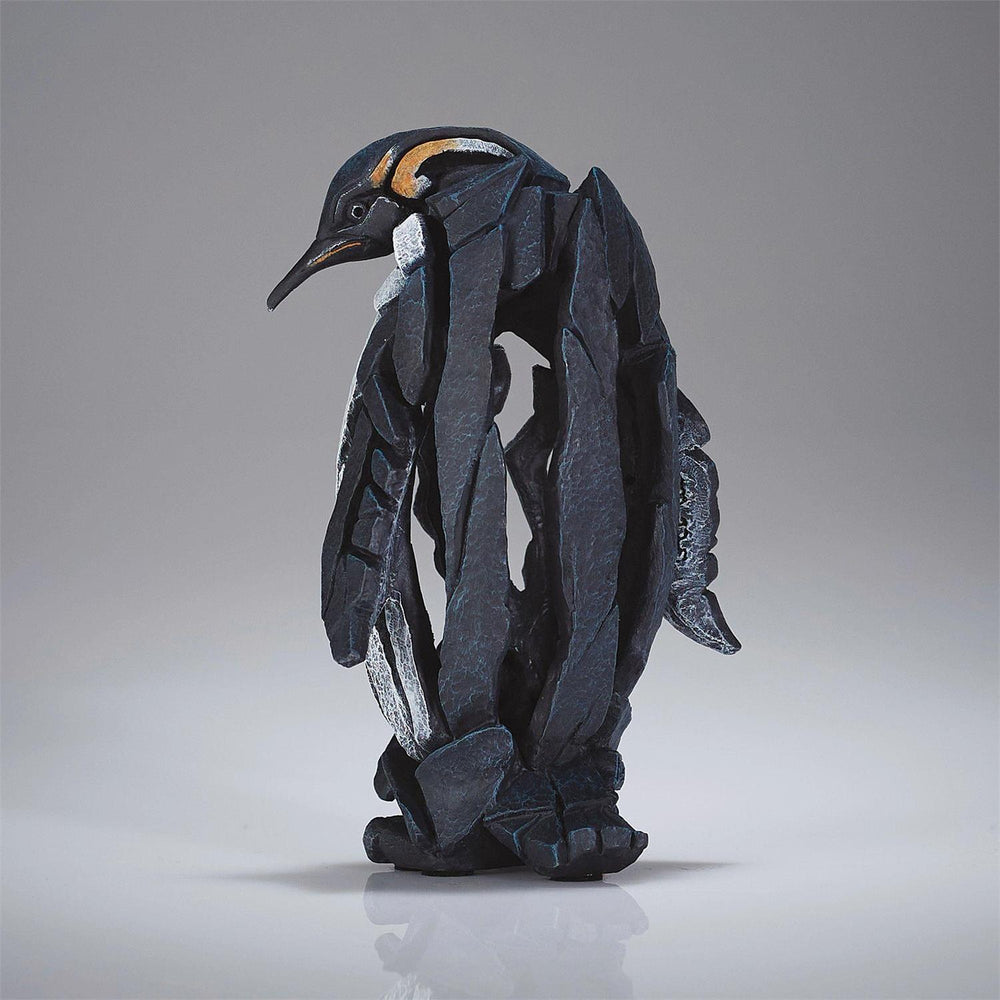 Penguin figurine on a gray background