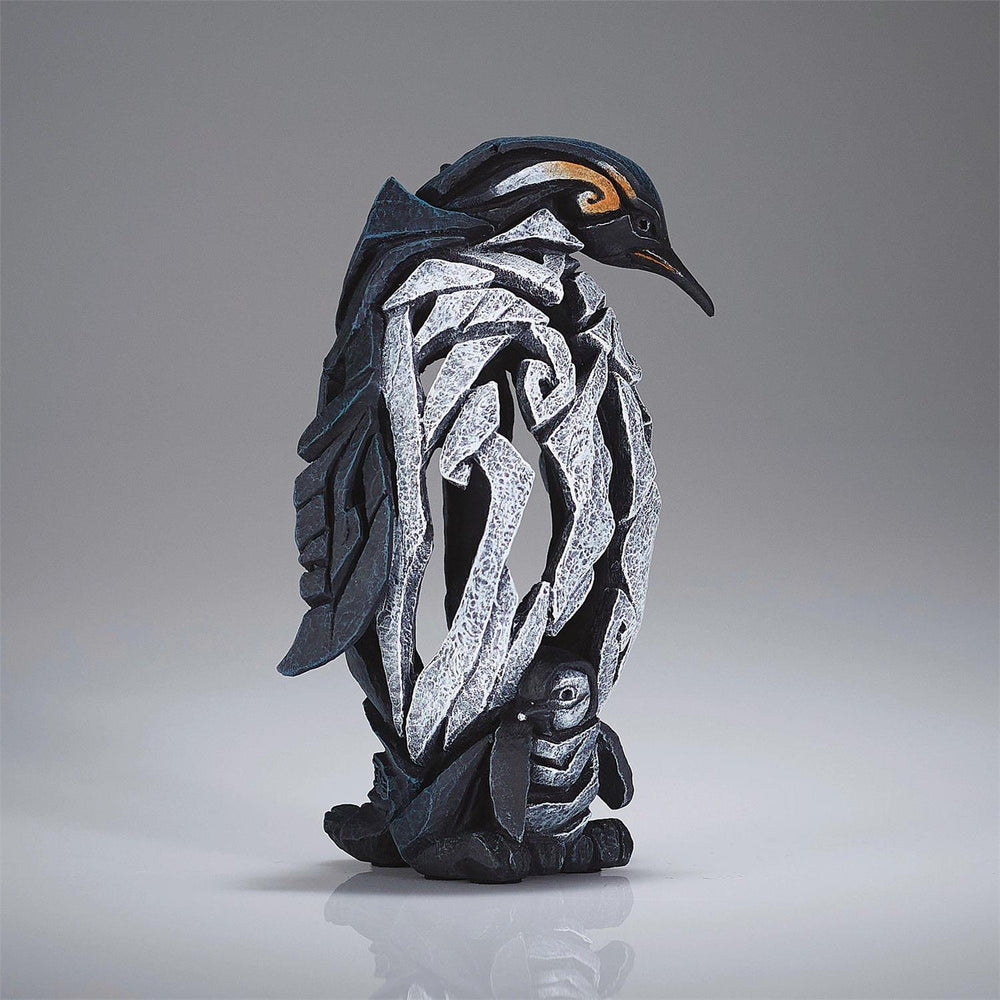 Decorative penguin sculpture with intricate patterns on a gray background