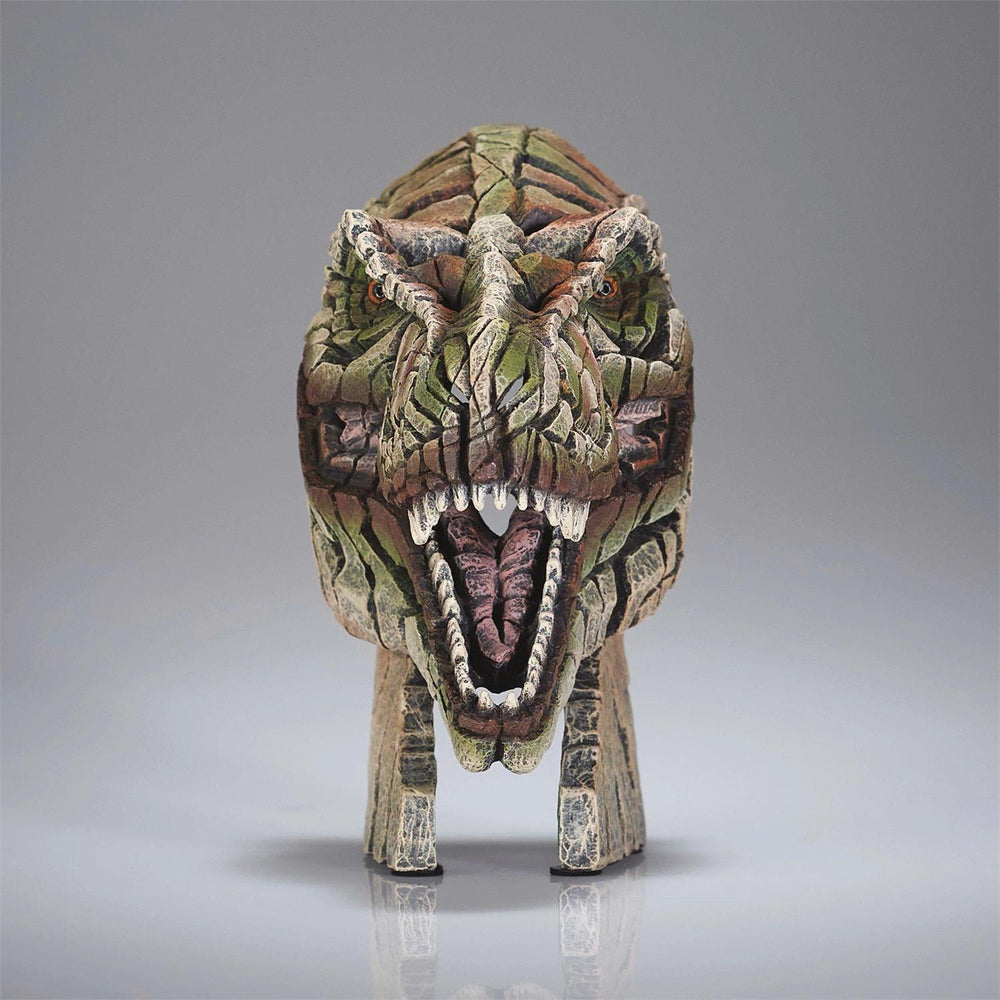Dinosaur head sculpture with a camouflage pattern on a gray background