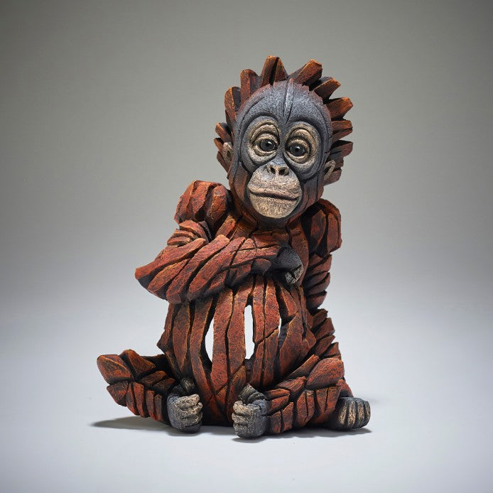 A sculpture of a baby orangutan, designed with a contemporary style.