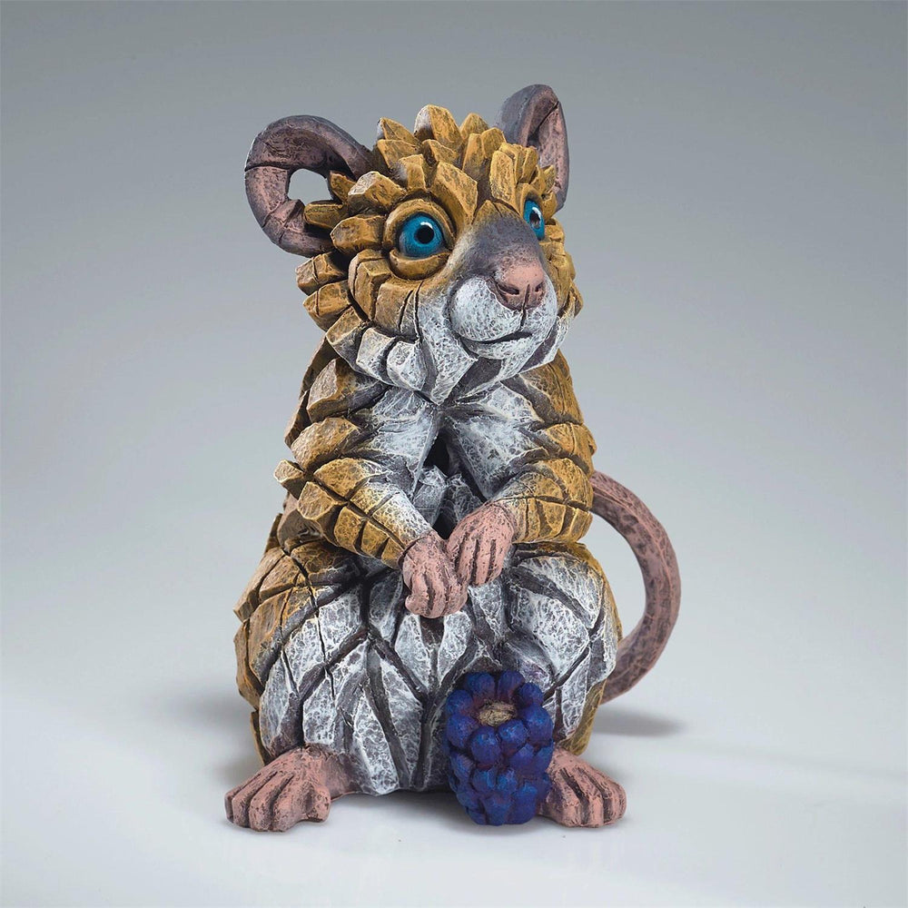 Artistic figurine of a stylized mouse with decorative elements on a plain background