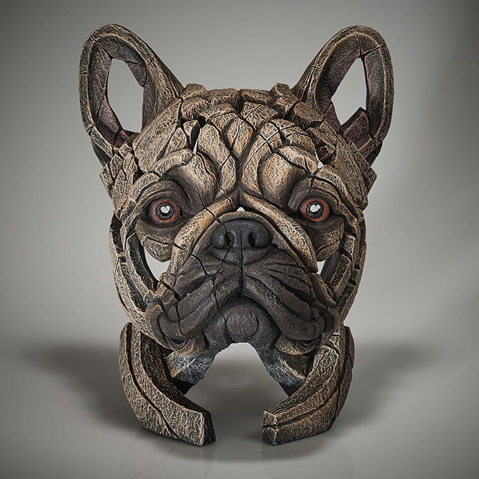 A sculpture of a French Bulldog's head in a rustic, textured finish with a black and brown color palette.
