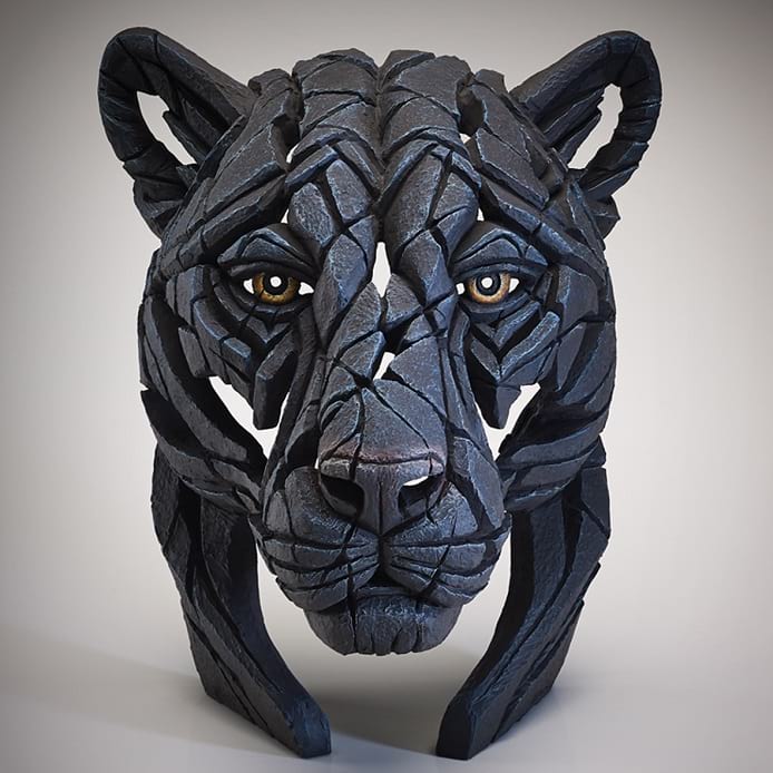 A black panther sculpture with a textured surface, created in a sculpting material that appears to be clay, and painted by hand.