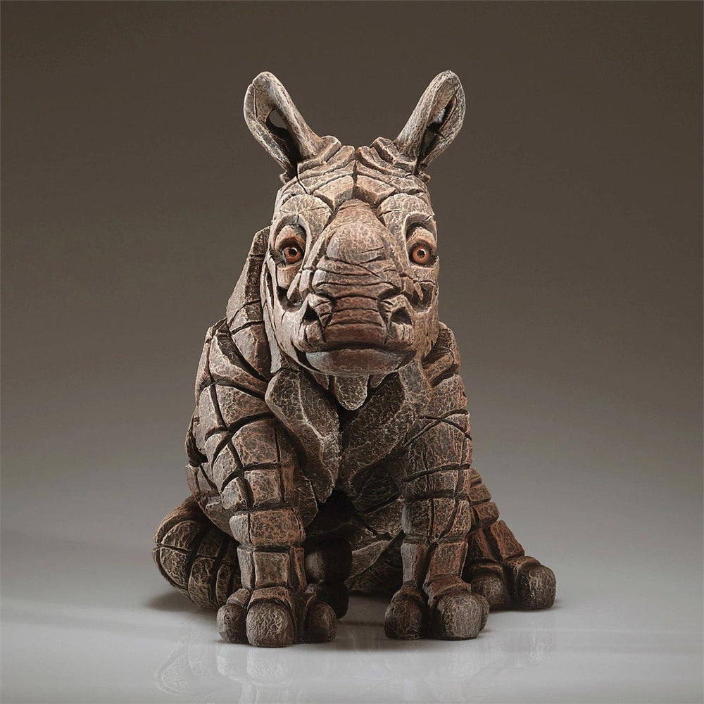 Stylized rhinoceros sculpture on a gray background