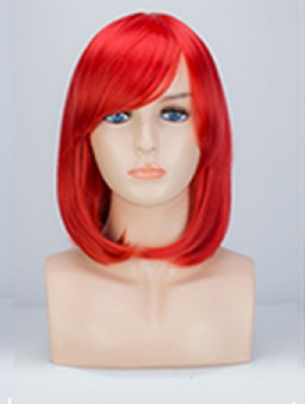 A bright red short bob wig with bangs displayed on a beige mannequin head and neck bust against a light gray background.