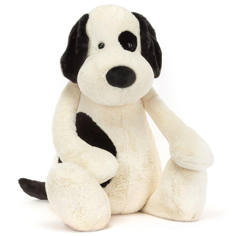 A large plush toy  black and cream puppy with a soft, silky texture.