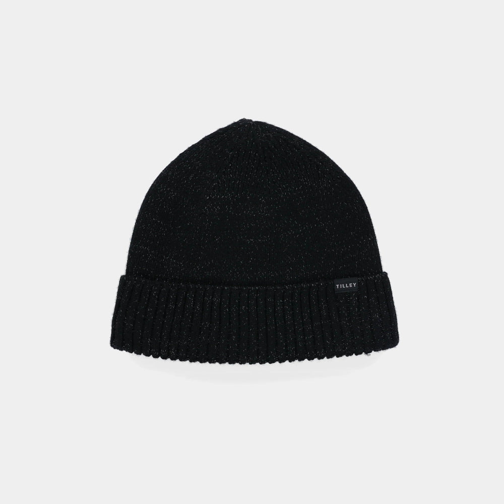 A black ribbed knit beanie hat with a small white 'TILLEY' brand tag on the side, displayed against a light gray background.
