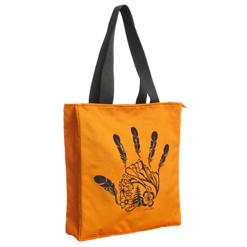 An orange recycled eco-bag with a black zipper and a black carrying handle, featuring a black printed indigenous hand design.