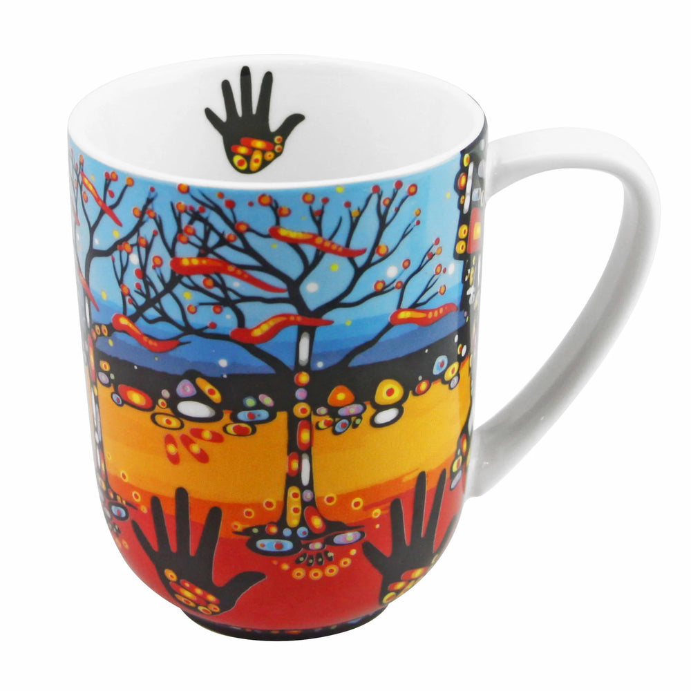 Colorful mug with artistic design of trees and hands on a white background