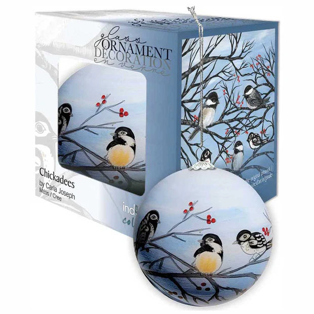 Decorative glass ornament with chickadees on a branch, displayed with packaging.