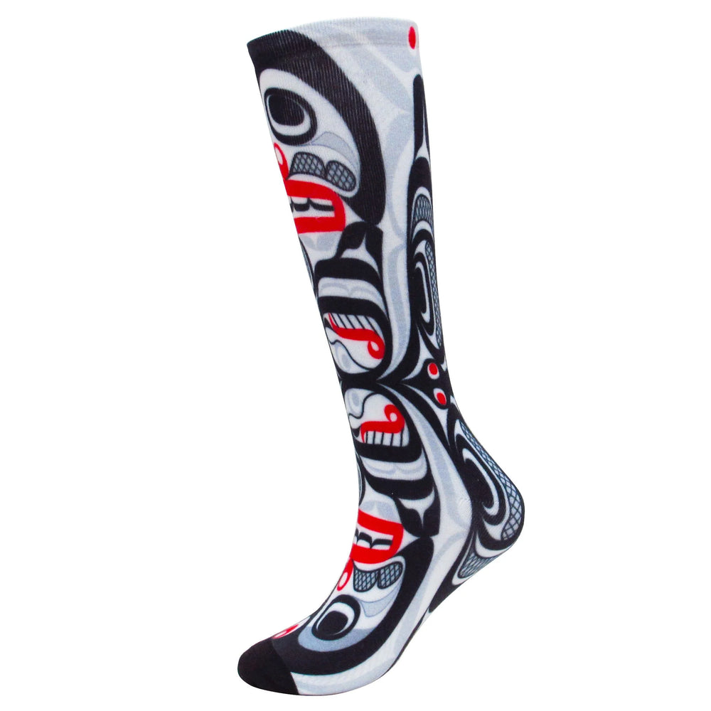 Knee-high sock with black, white, and red design on a white background