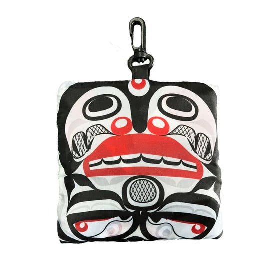Small pouch with a face design featuring black, white, and red colors on a white background.