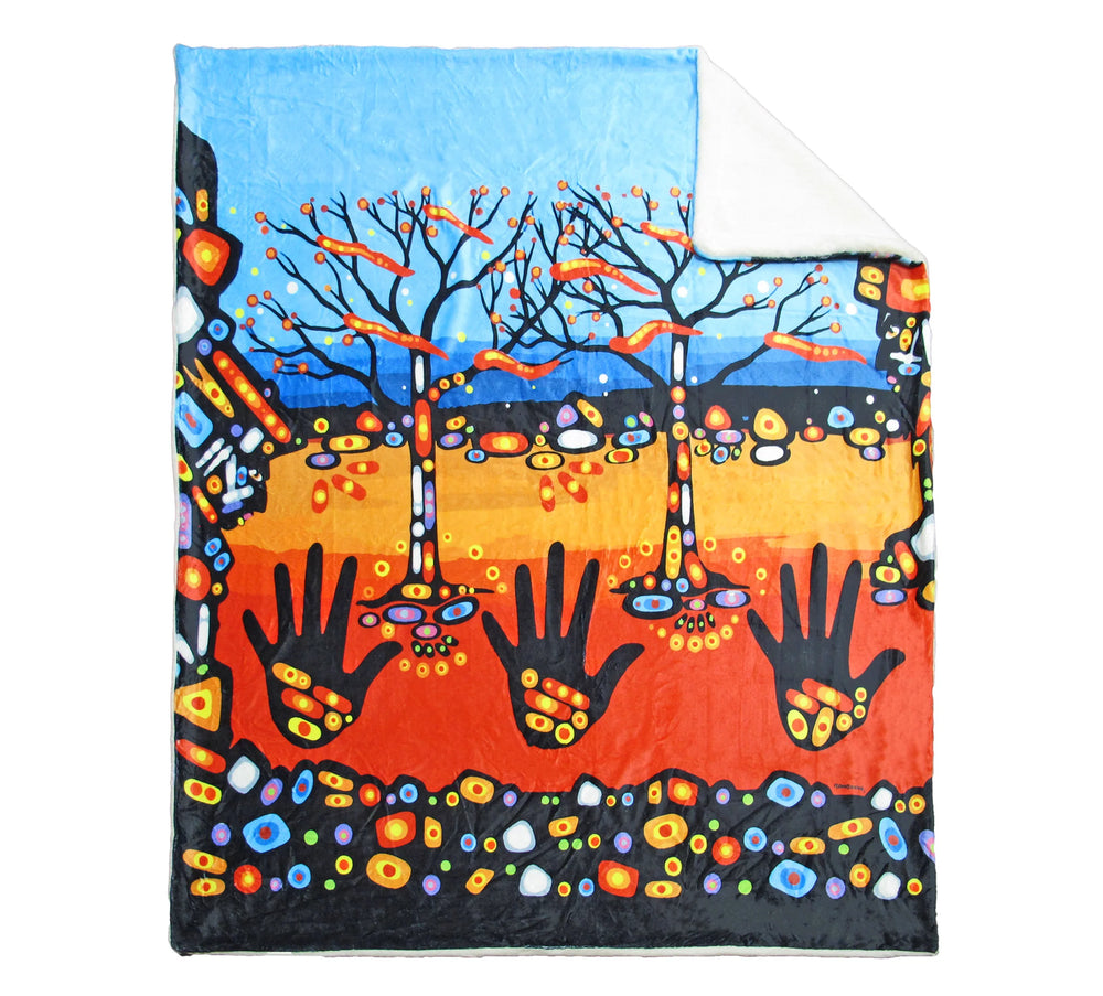 Colorful blanket with artistic design of trees and hands on a white background