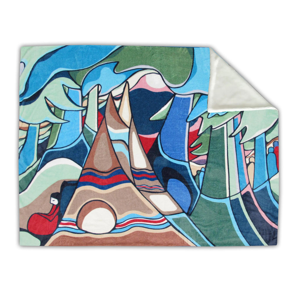 Colorful blanket with mountain and nature design on a white background