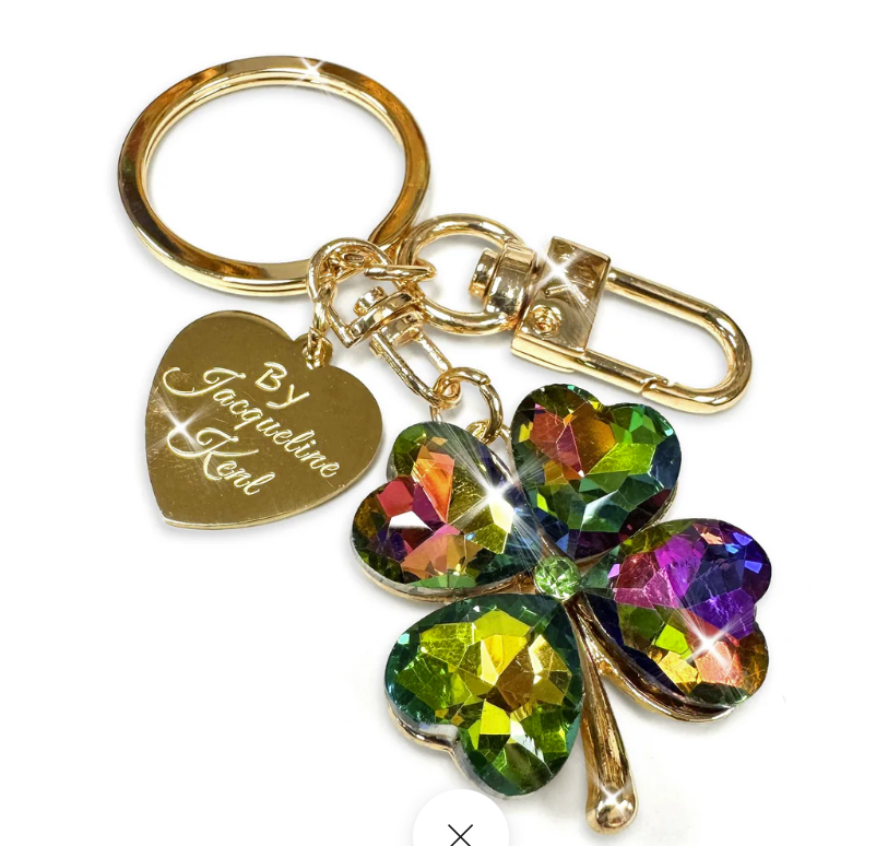 Keychain with rainbow-colored clover charm and gold heart tag on a white background