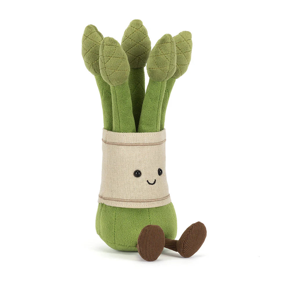 Plush toy of green asparagus with a smiling face on a white background