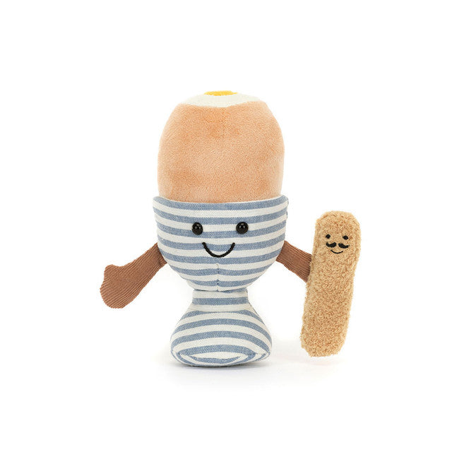 Plush toy resembling a boiled egg with a smiling face, striped pattern, and additional plush arms on a white background.