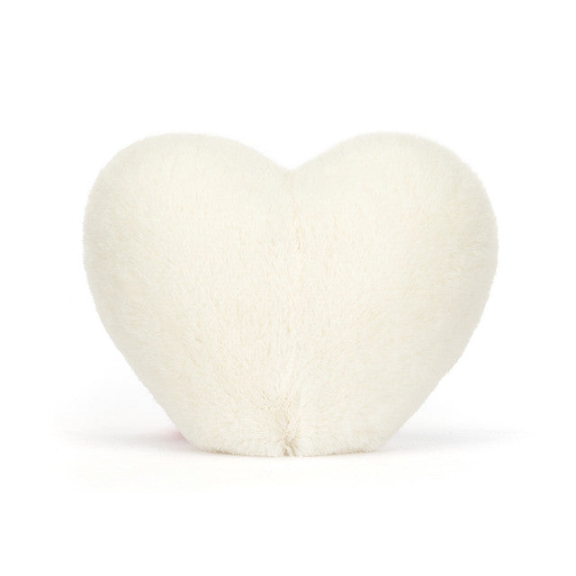 Heart-shaped white pillow on a white background