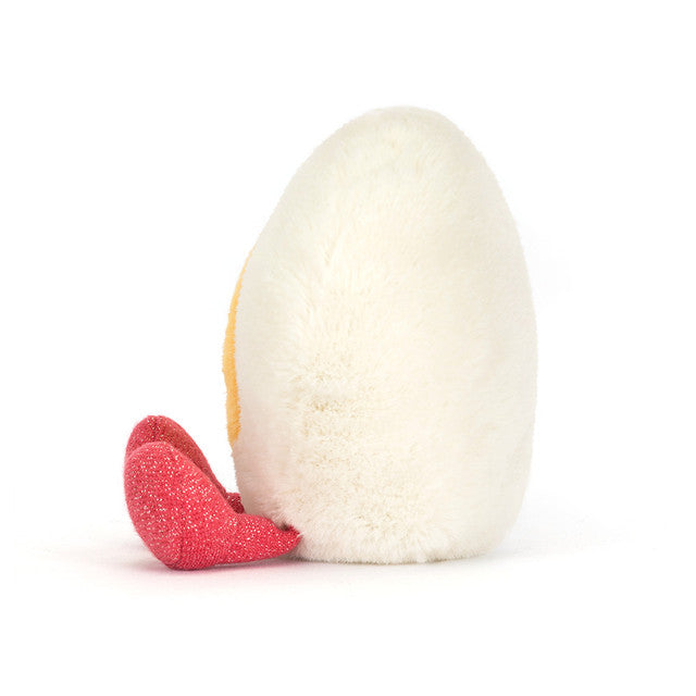 White plush toy resembling a chicken with a red foot on a white background
